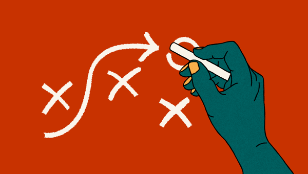 An illustration of a hand drawing shapes of a strategic nature, such as an arrow, crosses and a circle, on a surface using chalk.