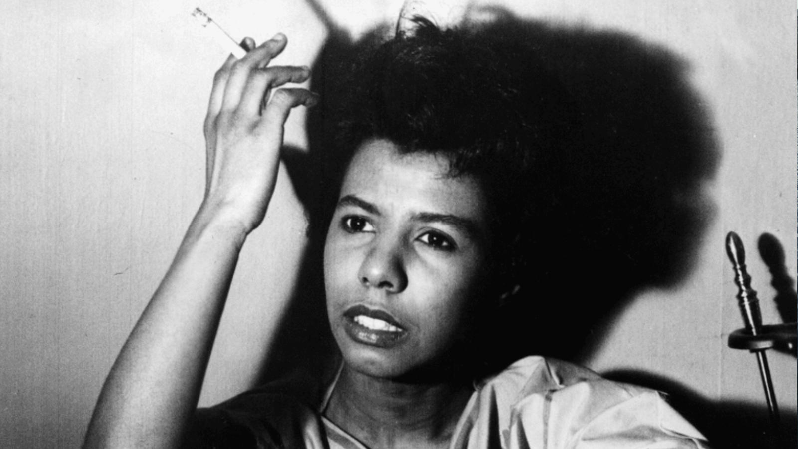 An image of Lorraine Hansberry in black and white smoking a cigarette.